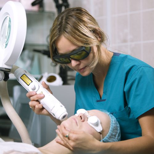 Woman undergoing laser skin treatment